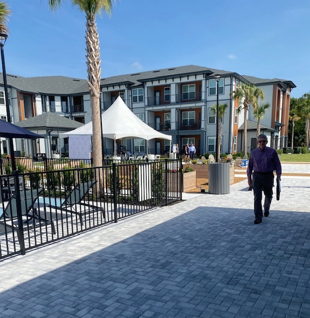 Man walking by Auburn Village pool.